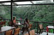 © Alexander Grabchilev/Stocksy - couple sitting at a table in a cafe overlooking the jungle