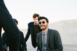 © sofie delauw/Stocksy - Crop content well dressed male coworkers speaking on rooftop