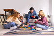 © VICTOR TORRES/Stocksy - Mother, father and kids playing with toys at home