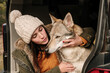 © Guaita Studio/Stocksy - Young woman in camper van petting a cute  wolf dog in the mountain