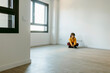 © Valentina Barreto/Stocksy - kid sitting on empty living room of his new house