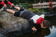 © Rob and Julia Campbell/Stocksy - Boy looking in lake water with goggles