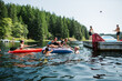 © Rob and Julia Campbell/Stocksy - Kids playing on air matress floaty on lake in summer.