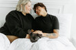 © Luke Liable/Stocksy - Married couple laying in bed together
