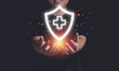 © Dilok - Businessman holding virtual protect health and insurance sign with copy space.