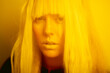 © Eloisa Ramos/Stocksy - Futurist close up blurred portrait of a beautiful woman looking at camera with enigmatic look with on yellow light