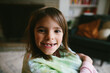 © Maria Manco/Stocksy - closeup of little kid with missing tooth