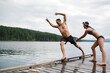 © Rob and Julia Campbell/Stocksy - Dad and daughter playing rough on lake dock