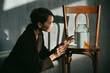 © Irina Polonina/Stocksy - Asian girl with an aquarium fish in a dark room.