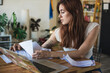 © Ana Luz Crespi/Stocksy - Personal Finance: Woman going through mortgage papers