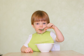 Wall Mural - Happy cute infant baby boy spoon eats itself