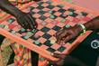 © Ogoh Clement/Stocksy - Men playing Draft board game