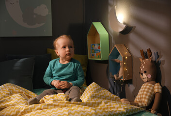 Canvas Print - Cute child in room with crescent shaped night lamp