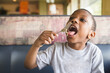 © Jennifer Bogle/Stocksy - Boy eats noodle at restaurant