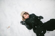© Maria Manco/Stocksy - overhead view of boy laughing in snow