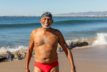 Man Stands In His Bathing Suit At The Beach