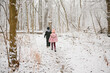 © Maria Manco/Stocksy - kids walk in snowy woods