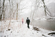 © Maria Manco/Stocksy - kids walk in snowy woods