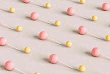 Pink Lollipop  And Yellow Candies On Pink Background