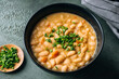 © Nataša Mandić/Stocksy - White beans soup topped with chives
