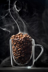 Glass mug with coffee beans and rising steam