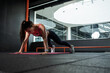 © nazarovsergey - Athletic woman performing push-ups during training at gym
