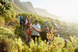 © Juno/Stocksy - Friends hiking outdoors at sunset