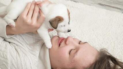 Sticker - Girl petting and playing with a small puppy