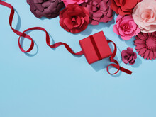 Red And Pink Paper Crafted Flowers And Roses. And A Paper Gift With Ribbon.