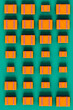 © Giada Canu/Stocksy - top view of orange suitcases on green background