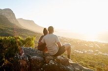 Couple Watching Sunset From A Viewpoint In Nature