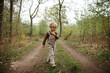 © Melissa Milis Photography/Stocksy - Toddler boy walking in the forest