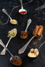 Star Anise, Cardamom, Cinnamon And Other Spices In Vintage Spoons