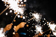 © Vladimir Tsarkov/Stocksy - Unrecognizable people holding Sparkler in hand