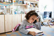© Jimena Roquero/Stocksy - Kid doing homework using electronic device