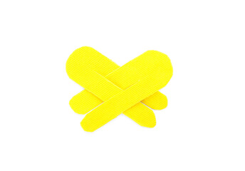 Wall Mural - Yellow kinesio tape pieces on white background, top view