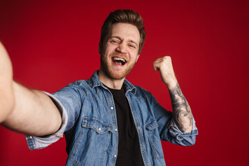 Happy smiling young man in casual clothes standing