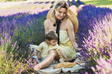 beautiful woman and her cute little son in the lavender field