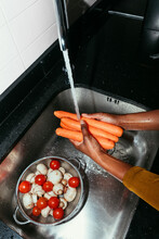 Woman Washing Carrots
