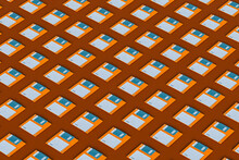Blue And Orange Floppy Disks Layed  On Brown Background 