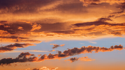 Wall Mural - Colorful and vibrant cloudscape view of majestic sky at sunset or sunrise. Dramatic and idyllic background