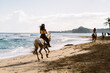 © Santi Nuñez/Stocksy - Woman Riding Horse Along Shore