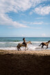 © Santi Nuñez/Stocksy - Woman Riding Horse Along Shore