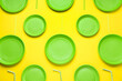 © New Africa - Plastic dishware on yellow background, flat lay