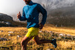 © Manu Prats/Stocksy - Crop of athlete doing sports training against fog