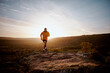 © StratfordProductions - Young fit male athlete running over rocky mountain trail on hill during sunrise