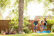 © Jennifer Bogle/Stocksy - Laughing children have water fight