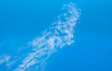 Wall Mural - Blue sky and white clouds background - Pillowy clouds cover a blue sky in the background