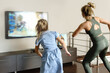 © blackday - Family dancing with modern video game console at home