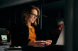© StratfordProductions - Successful young smiling portrait of a businesswoman typing on laptop in modern office